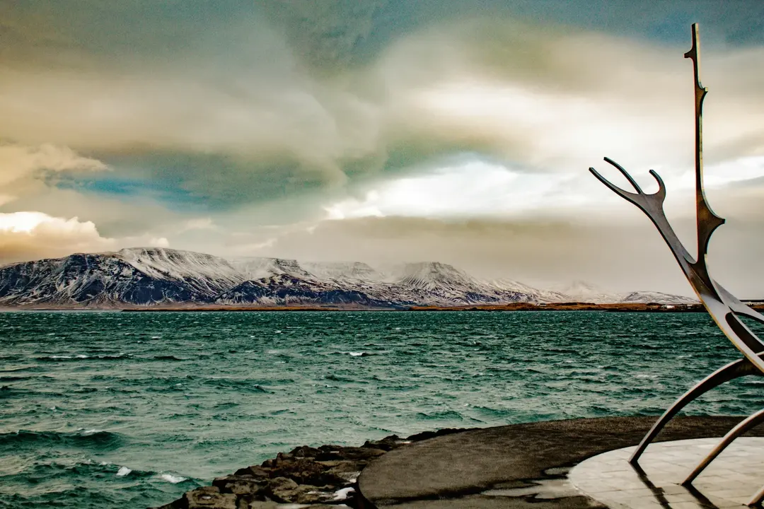 Paisagem de Reykjavik com montanhas nevadas e mar, destino na Europa perfeito para explorar em 2025